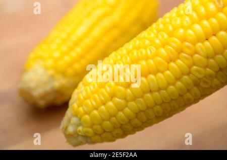 delicious two boiling corn in wooden table Stock Photo - Alamy