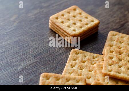 Groceries, snacks, food. Salted crispy crackers on a wooden table. Stock Photo