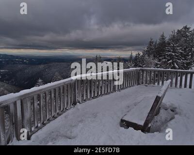 Stunning view over Black Forest hills with Rhine valley and Vosges on the horizon from snow-covered observation deck on Schliffkopf peak, Germany. Stock Photo