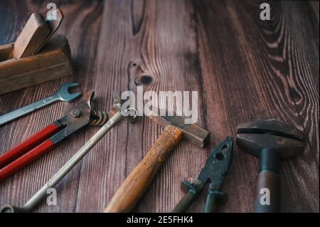 Dirty set of vintage hand tools on wooden background Stock Photo