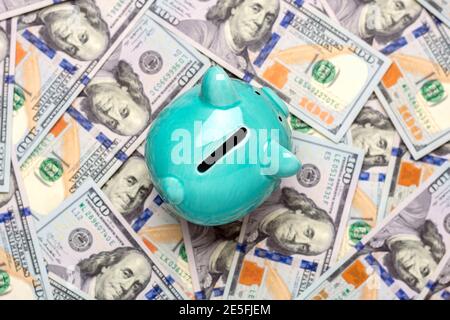 piggy bank, dollars banknote on blue background Buying, sale, investment, banking, loan, insurance concept Flat lay Top view Business and finance Stock Photo