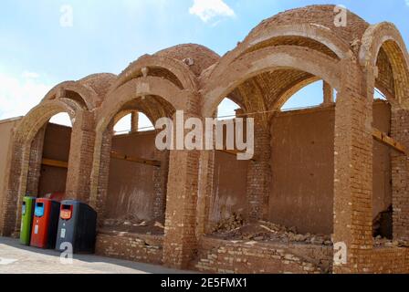Three colored recycling wheelie bins for sorting waste on street. Yazd Iran.  Stock Photo