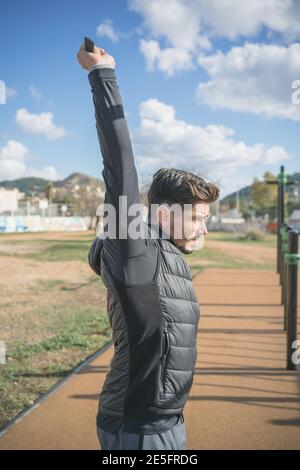 athletic man doing stretching exercises before doing sports Stock Photo