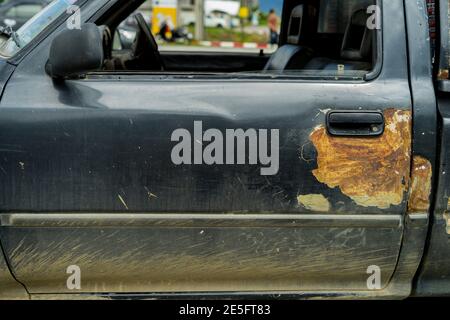 Rusty car door with handle ,Old  car door handle bar it still good working in Thailand close up image. Stock Photo