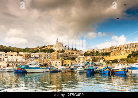 Port of the island of Gozo with its fishing boats, in Malta in the far south of Europe Stock Photo