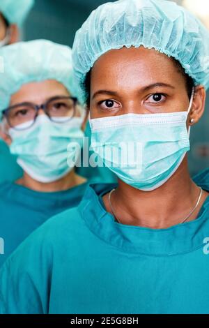 Successful team of surgeon standing in operating room, ready to work on a patient Stock Photo