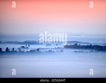 Misty views from the Cotswold Escarpment near Wotton-under-Edge in Gloucestershire towards Tortworth and the first Severn Bridge UK