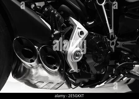 Luxury sport bike engine fragment with exhaust pipes, close up black and white photo Stock Photo