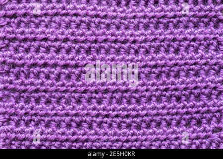 Handmade close-up simple lilac crochet pattern for background Stock Photo