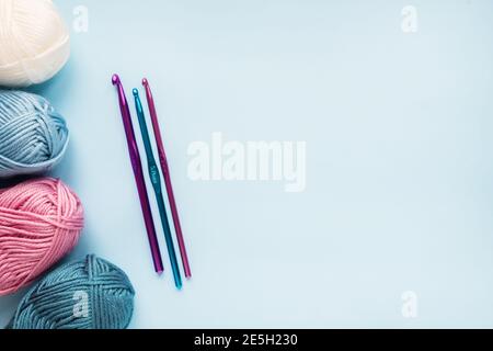 knitting pink crochet hooks and woolen thread on a blue background Stock  Photo - Alamy