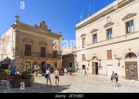 Erice, Sicily, Italy - August 25, 2017: Tourists visit Piazza della Loggia in the ancient town of Erice Stock Photo