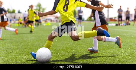 Young Football Players Kicking Ball on Soccer Field. Soccer Horizontal  Background. Youth Junior Athletes in Red and Blue Soccer Shirts - Raising  Arizona Kids Magazine
