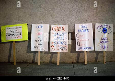 A collection of signs are seen on the street during a protest organized by the San Francisco Taxi Workers Alliance against ridesharing services Uber and Lyft outside the 8th Annual Crunchies Awards in San Francisco, California February 5, 2015. App-based ride service Uber, and smaller rival Lyft, face separate lawsuits seeking class action status in San Francisco federal court, brought on behalf of drivers who contend they are employees and entitled to reimbursement for expenses, including gas and vehicle maintenance. The drivers currently pay those costs themselves. REUTERS/Stephen Lam (UNITE