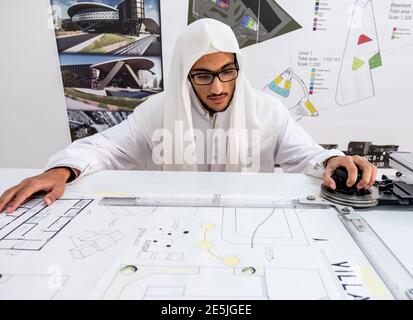 Arab architect preparing his desk to start making his sketch Stock Photo