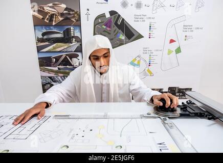 Arab architect preparing his desk to start making his sketch Stock Photo