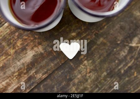 Enameled Two cups of tea in nature on wooden background, love, heart of marshmallow, travel concept, Lifestyle moment at nature, Valentine day, copy s Stock Photo