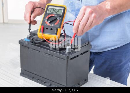 Testing car battery with digital multimeter Stock Photo