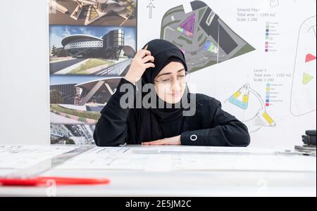 Arab female architect feeling tired and thinking Stock Photo