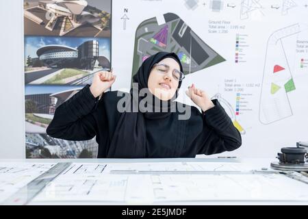 Arab female architect feeling tired Stock Photo
