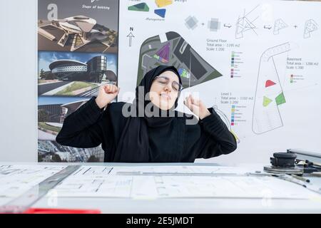Arab female architect feeling tired Stock Photo