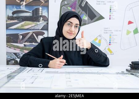 Female architect working and showing thump up Stock Photo