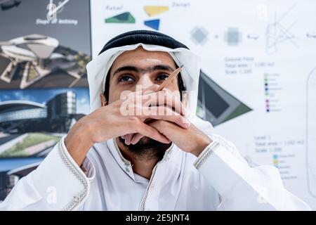 Arab male architect thinking and looking at his pencil Stock Photo