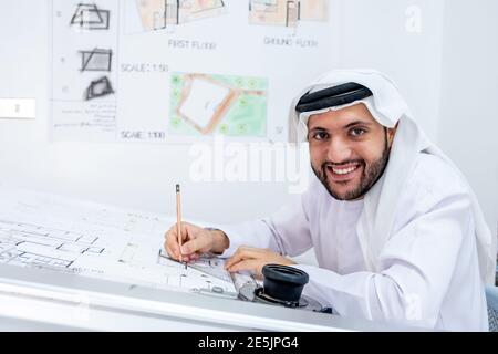 Arabic architecture working on his project and smiling Stock Photo