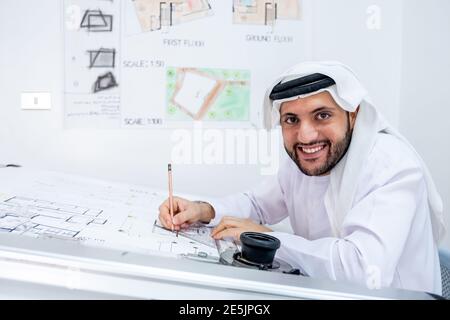 Arabic architecture working on his project and smiling Stock Photo