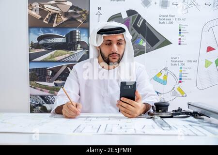 Arabic architecture enjoying online call while working on his project Stock Photo