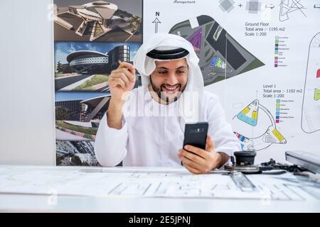 Arabic architecture enjoying online call while working on his project Stock Photo