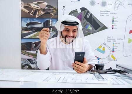 Arabic architecture enjoying online call while working on his project Stock Photo