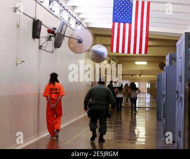 An inmate is led by a prison guard at the California Institution for Men state prison in Chino, California, June 3, 2011. The Supreme Court has ordered California to release more than 30,000 inmates over the next two years or take other steps to ease overcrowding in its prisons to prevent 'needless suffering and death.' California's 33 adult prisons were designed to hold about 80,000 inmates and now have about 145,000. The U.S. has more than 2 million people in state and local prisons. It has long had the highest incarceration rate in the world. REUTERS/Lucy Nicholson (UNITED STATES - Tags: CR
