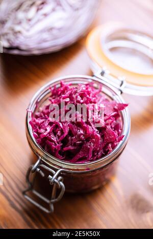 Red sauerkraut. Sour pickled cabbage in jar. Stock Photo