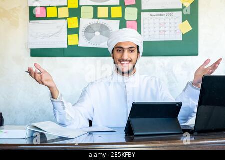 Happy male coach teacher webinar speaker looking at camera giving online class lecture or making conference video chat call, smiling Muslim businessman Stock Photo