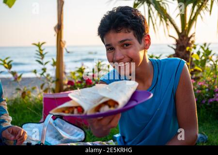 Yong boy is showing his favourite sandwich Stock Photo