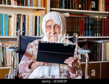 Old woman is using technology Stock Photo