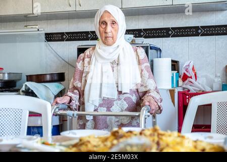Old woman is using walker Stock Photo