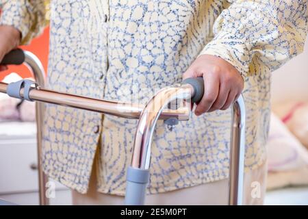 Muslim woman is using a walker Stock Photo