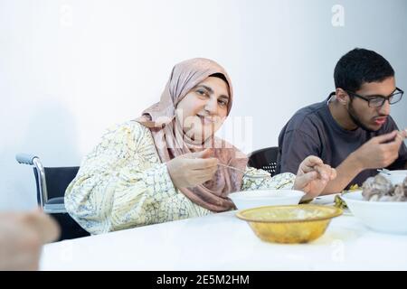 Muslim family eating their meal together Stock Photo