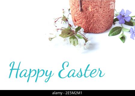 Traditional delicious Easter cake and fresh spring flowers isolated on white background. With inscription Happy Easter Stock Photo