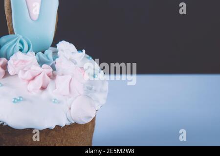 Traditional delicious Easter cake with marshmallow and rabbit ears on contrast background. Side view Stock Photo