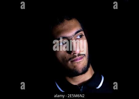 ortrait of middle eastern guy in a dark room Stock Photo