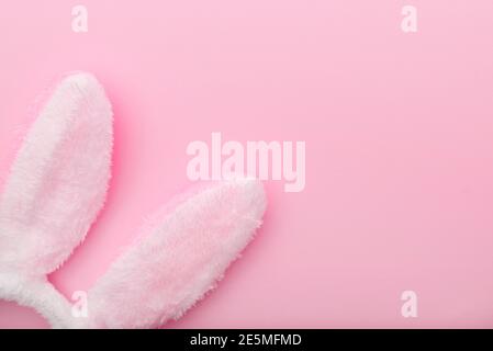 White rabbit ears on pink background, Easter minimal flat lay, top view, space for text Stock Photo