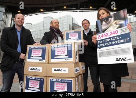 Members of Avaaz.org activists group bring boxes symbolising 2,442,240 signatures of a petition against ACTA (Anti-Counterfeiting Trade Agreement) to the European Parliament in Brussels February 28, 2012. Avaaz.org fear that ACTA, which aims to cut trademark theft and other online piracy, will curtail freedom of expression, curb their freedom to download movies and music for free and encourage Internet surveillance. REUTERS/Eric Vidal (BELGIUM - Tags: POLITICS SOCIETY)