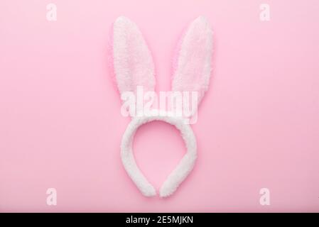 White rabbit ears on pink background, Easter minimal flat lay, top view, space for text Stock Photo