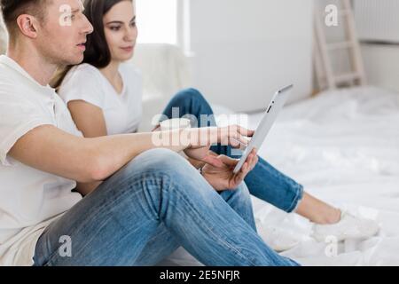 young couple making online purchases in their apartment Stock Photo