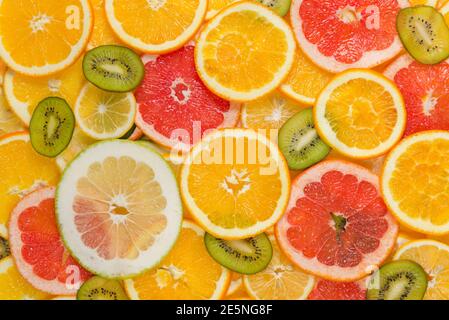 Sliced healthy fresh fruits. Rings of grapefruit, kiwi, lemon and orange Stock Photo