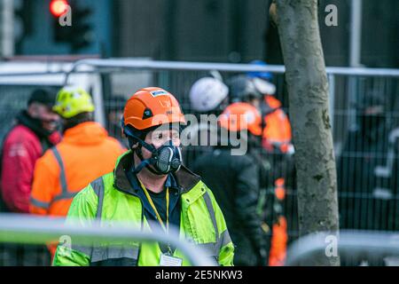 EUSTON SQUARE LONDON, UK  28 January 2021.  Bailiffs wearing protective facemasks prepare to evict a group of protesters from StopHS2 rebellion  who have set up camp in tree houses  in Euston Square gardens. Credit: amer ghazzal/Alamy Live News Stock Photo