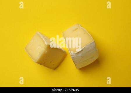 Delicious camembert cheese slices on yellow background, close up Stock Photo