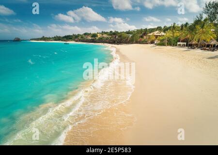 Aerial view of white sandy beach, ocean with waves at sunset Stock Photo